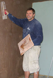 plasterer plastering a wall
